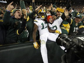 Packers wide receiver Davante Adams celebrates a touchdown with fans during the second half of an NFL game against the Bears in Green Bay, Wis., on Thursday, Oct. 20, 2016. (Matt Ludtke/AP Photo)
