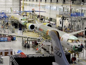 People tour the Bombardier Global 7000 aircraft and facility in Toronto on Tuesday, November 3, 2015. Bombardier says it is cutting another 7,500 jobs around the world over the next two years, including about 2,000 across Canada. (THE CANADIAN PRESS/Nathan Denette)