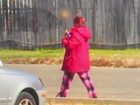 A homeless woman led Sacramento, California cops to a decoposed body. The woman was seen walking down the street with a human skull on a stick. (Screen Capture)