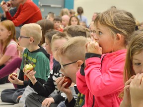 Mercy Wysman munches on an apple at Georges P. Vanier Catholic School in Chatham. She was one of thousands of students across Chatham-Kent who participated in the Big Crunch Oct. 20, an Ontario-wide initiative pushing students to eat healthier.