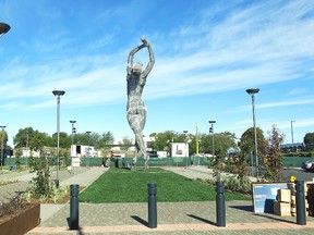 In this photo taken Wednesday Oct. 19, 2016, a 55-foot nude statue stands in San Leandro, Calif. The statue of a naked woman is stirring controversy and a lot of conversation. City officials and the sculptor of the steel nude, which was unveiled this week across from San Leandro's main commuter train stop, say they want to draw attention to "feminine energy." Critics say the 13,000-pound towering nude is not appropriate public art. (AP Photo/Jocelyn Gecker)