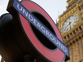 A London Underground Station sign is pictured against the backdrop of the Houses of Parliament in London on February 5, 2014. Police have arrested a 19-year-old man on suspicion of terrorism after a package was discovered on a London subway train. (ANDREW COWIE/AFP/Getty Images)