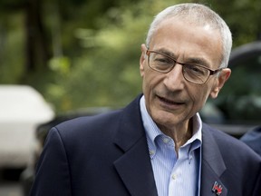 In this photo taken Oct. 5, 2016 file photo, Hillary Clinton's campaign manager John Podesta speaks to members of the media outside Democratic presidential candidate Hillary Clinton's home in Washington. (AP Photo/Andrew Harnik, File)