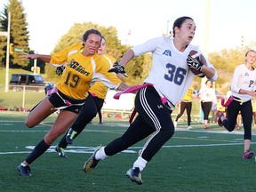 Emily Tilbury of the Bishop Alexander Carter Gators chases down Allison Byrnes of the Marymount Academy Regals during division a high school flag football action from James Jerome Field in Sudbury, Ont. on Tuesday September 20, 2016. Gino Donato/Sudbury Star/Postmedia Network