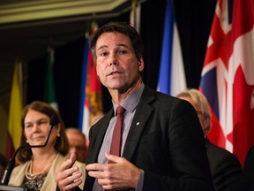 Ontario Health Minister Eric Hoskins, centre, speaks as Federal Health Minister Jane Philpott, left, looks on during a federal, provincial and territorial health ministers' meeting in Toronto on Tuesday, October 18, 2016. (THE CANADIAN PRESS/Christopher Katsarov)