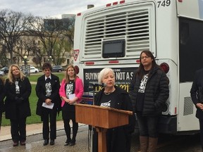 Joy Smith, former MP and President and Founder of Joy Smith Foundation, addresses the press conference for the "Buying Sex is not a Sport" on Friday, Oct. 21, 2016, in front of the Manitoba Legislature. Behind Smith is human trafficking survivor and victims advocate Alaya McIvor.