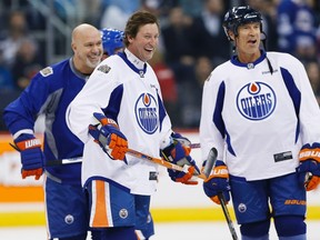 Former Edmonton Oilers, from left, Charlie Huddy (22), Wayne Gretzky (99) and Mark Messier (11) joke around during a practice for the NHL's Heritage Classic Alumni game in Winnipeg on Friday, October 21, 2016. Winnipeg will host games between current and alumni players from the Winnipeg Jets and Edmonton Oilers this weekend. THE CANADIAN PRESS/John Woods