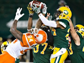 B.C. Lions' Emmanuel Arceneaux (84) tries to get the pass as Edmonton Eskimos Brandyn Thompson (24) makes the interception during second half CFL action in Edmonton, Alta., on Friday September 23, 2016