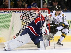 London Knights forward Janne Kuokkanen tries to jam a puck past Saginaw goalie Evan Cormier after getting around Keaton Middleton of the Spirit during the first period of their OHL game at Budweiser Gardens on Friday night. (MORRIS LAMONT, The London Free Press)