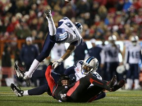 Calgary Stampeders' Andrew Buckley collides with Toronto Argonauts' Eric Martin during CFL action at McMahon Stadium in Calgary on Oct. 21, 2016. (Leah Hennel/Postmedia)