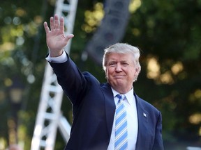 Donald Trump waves to the crowd after finishing his speech at a campaign stop at Regent University in Virginia Beach, Va., on Saturday, Oct. 22, 2016. (Steve Earley/The Virginian-Pilot via AP)