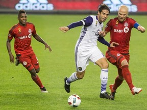 Orlando City’s Kaka (centre) battles with Toronto FC’s Michael Bradley (right) last month. Bradley says the Reds have “everything to play for” as the playoffs loom next week. (THE CANADIAN PRESS/PHOTO)