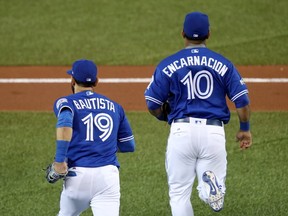 Jose Bautista and Edwin Encarnacion of the Toronto Blue Jays take the field prior to game five of the American League Championship Series against the Cleveland Indians at Rogers Centre on October 19, 2016 in Toronto, Canada. (Photo by Tom Szczerbowski/Getty Images)