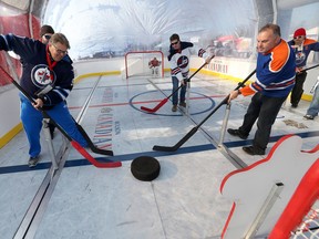 Hockey fans, including Dancing Gabe, play a game inside an inflated bubble on campus at the University of Manitoba, prior to watching the NHL Winnipeg Jets Alumni play the NHL Edmonton Oilers Alumni, outside, in Winnipeg. Friday, October 21, 2016. (Winnipeg Sun/Postmedia Network)