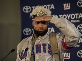 New York Giants wide receiver Odell Beckham Jr. shields his eyes from a spotlight during a press conference at Syon House in Syon Park, south west London, Friday. (AP Photo/Matt Dunham)