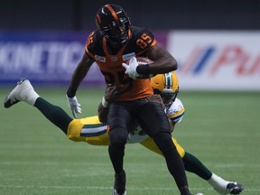 Edmonton Eskimos linebacker Deon Lacey (40) tackles BC Lions slotback Shawn Gore (85) during the second half of CFL football action, in Vancouver on Saturday, Oct. 22, 2016.