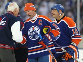 Edmonton Oilers centre Wayne Gretzky speaks with Winnipeg Jets coach Ab McDonald after the Heritage Classic alumni game. (KEVIN KING/Winnipeg Sun)