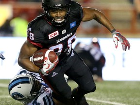 Stampeders’ Kamar Jorden is tackled by the Argonauts’ Marcus Alford at McMahon Stadium in Calgary on Friday. With the loss, the Argos fell to 5-13 on the season. (Leah Hennel/Postmedia Network)
