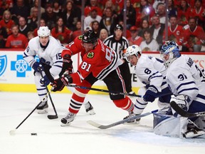 Chicago Blackhawks right winger Marian Hossa (81) reaches for the puck between Toronto Maple Leafs left winger Matt Martin (15), defenceman Connor Carrick (8) and goalie Frederik Andersen (31) during the second period of an NHL hockey game Saturday, Oct. 22, 2016, in Chicago. (JEFF HAYNES/AP)