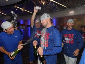 Jon Lester of the Chicago Cubs celebrates in the clubhouse after defeating the Los Angeles Dodgers 5-0 in game six of the National League Championship Series to advance to the World Series against the Cleveland Indians at Wrigley Field on October 22, 2016 in Chicago, Illinois. (Jonathan Daniel/Getty Images)