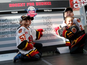 Kids who participated in the Hockey for Hunger food drive challenge point to their team's total number of food items collected, Sunday October 23, 2016 at the Quinte Mall in Belleville, Ont. 

Emily Mountney-Lessard/Belleville Intelligencer/Postmedia Network