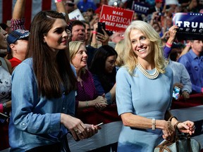 Kellyanne Conway, campaign manager for Republican presidential candidate Donald Trump, right, and press secretary Hope Hicks watch during a campaign rally, Friday, Oct. 14, 2016, in Charlotte, N.C. (AP Photo/ Evan Vucci)