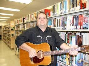 Bothwell musician Jay Allan was one of the "books" during Saturday's human library at the Chatham-Kent Public Library. Visitors could have one-on-one conversations with people on various topics. (Trevor Terfloth/The Daily News)