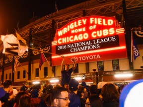 Chicago Cubs fans celebrate outside Wrigley Field after the Cubs defeated the Los Angeles Dodgers in Game 6 of baseball's National League Championship Series, Oct. 22, 2016, in Chicago. The Cubs advanced to the World Series. (AP PHOTO)