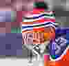 Edmonton Oilers goalie Cam Talbot wears a toque over his helmet during NHL Heritage Classic hockey in Winnipeg, Man. Sunday October 23, 2016.