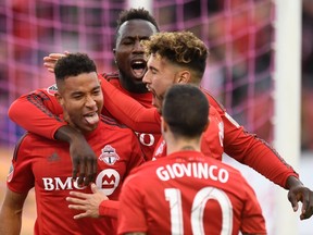 Toronto FC's Justin Morrow (left) celebrates his goal with teammates Sebastian Giovinco, Jonathan Osorio (right) and Jozy Altidore (back) against the Chicago Fire during second-half MLS soccer action in Toronto on Sunday. (THE CANADIAN PRESS)