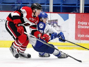 Ryan Orban of the Ottawa 67's  and Darian Pilon of the Sudbury Wolves battle for the puck during OHL action from the Sudbury Community Arena in Sudbury, Ont. on Sunday October 23, 2016. Gino Donato/Sudbury Star/Postmedia Network