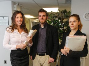 Lawyer Jodie-Lee Primeau, left, and Queen's University law students William McDiarmid and Olga Michtchouk of the Queen's Law Clinic. (Julia McKay/The Whig-Standard)