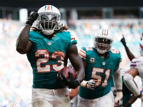 Dolphins running back Jay Ajayi (23) celebrates a touchdown during second half NFL action against the Bills in Miami Gardens, Fla., on Sunday, Oct. 23, 2016. (Wilfredo Lee/AP Photo)