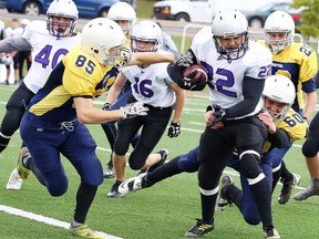 James Colburne and Xavier Bruneau of the College Notre Dame Alouettes take down Borna Mahdavi of the Lo Ellen Knights during senior high school boys football action in Sudbury, Ont. on Friday October 14, 2016. Lo Ellen defeated College Notre Dame.Gino Donato/Sudbury Star/Postmedia Network