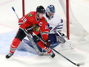 Maple Leafs goalie Frederik Andersen deals with the crease presence of Chicago Blackhawks centre Jonathan Toews during the overtime period on Saturday in Chicago. (AP/PHOTO)