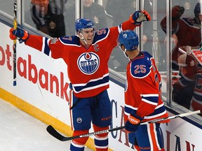 Edmonton Oilers' Darnell Nurse (25) and Connor McDavid (97) celebrate Nurse's goal against the Winnipeg Jets during second period NHL Heritage Classic action in Winnipeg on Sunday, October 23, 2016. THE CANADIAN PRESS/John Woods