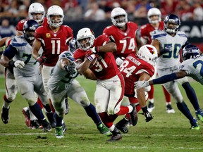 Arizona Cardinals running back David Johnson (31) runs as Seattle Seahawks middle linebacker Bobby Wagner, left, reaches in for the tackle during the second half of a football game, Sunday, Oct. 23, 2016, in Glendale, Ariz. (AP Photo/Ross D. Franklin)