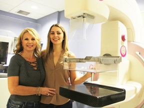 Carrie Murray-Bondy stands by a mammogram machine at Sarnia's hospital with her daughter Victoria Bondy. Murray-Bondy's breast cancer was detected by mammogram in 2013. Tyler Kula/Sarnia Observer/Postmedia Network