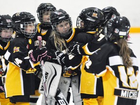 Mitchell Novice ‘C’ goalie Grace Kipfer is mobbed by teammates after their team opened the 11th annual Mitchell girls hockey tournament Oct. 20 with a convincing win over Lucan. Mitchell went 3-0 in pool play and advanced to the final against Kincardine Sunday, but fell one goal short in a 2-1 loss. ANDY BADER MITCHELL ADVOCATE