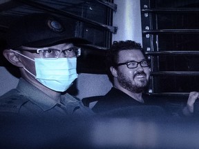 This file photo taken on November 10, 2014 shows British banker Rurik Jutting (R), charged with the grisly murders of two Indonesian women, smiling as he sits in a prison van leaving the eastern court in Hong Kong. Jutting pleaded "not guilty" to two charges of murder on October 24, 2016, as he stood trial for the killings of two Indonesian women who were found in his upscale Hong Kong apartment. (AFP PHOTO / Philippe LOPEZPHILIPPE LOPEZ/AFP/Getty Images)