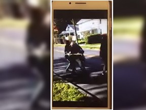 Two teen girls have been arrested over a disturbing video that appears to show them beating a 62-year-old man in Syracuse, N.Y., who asked them to stop sitting on his lawn, say police. (YouTube screen grab)