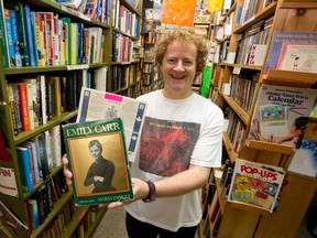 City Lights Bookstore co-owner Jim Capel holds a biography of Emily Carr, inside which a $10,000 Canada savings bond from 1981-82 was found, in the Richmond Street bookshop in London. Craig Glover/The London Free Press/Postmedia Network