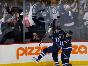 Winnipeg Jets' Nikolaj Ehlers (27) and Patrik Laine (29) celebrate Patrik Laine's (29) game winning goal and hat-trick during overtime against the Toronto Maple Leafs in NHL action in Winnipeg on Wednesday, October 19, 2016.