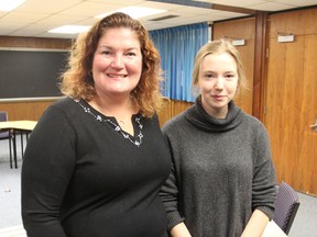 Sherri Agnew, left, chair of the local Rotary Exchange program, stands with Aza Mather, who went to Sweden on the program last year, at Aza's school in Kingston. (Michael Lea/The Whig-Standard)