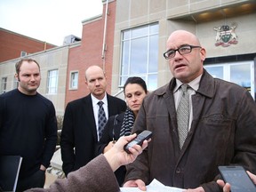 Chris Hein speaks on behalf of the Rochette family as Justin Stewart, Ryan Kirwan and Angel Kirwan look on outside the courthouse in Sudbury on Monday. (Gino Donato/Sudbury Star)