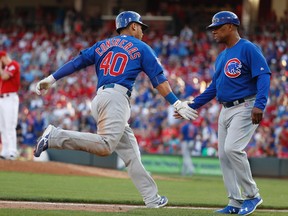 Former Edmonton Trappers GM and current Chicago Cubs third base coach Gary Jones, seen here celebrating a Wilson Contreras home run against the Cincinnati Reds on Oct. 8, is one of several connections Edmonton has to the 2016 World Series. (AP Photo)