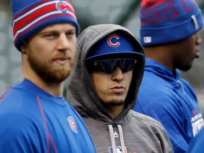 Cubs third baseman Javier Baez (center) watches the warm ups during a team practice for the upcoming World Series against the Indians in Cleveland on Monday, Oct. 24, 2016. (David J. Phillip/AP Photo)