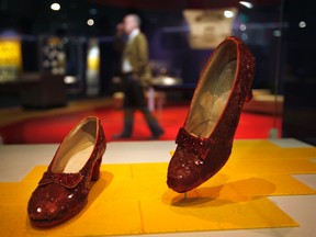 In this April 11, 2012, file photo, Dorothy's Ruby Slippers, from the "Wizard of Oz" are on display as part of a new exhibit, "American Stories," at the Smithsonian National Museum of American History in Washington. The Smithsonian launched a Kickstarter campaign to raise $300,000 to help preserve the slippers that whisked Dorothy back to Kansas at the end of the movie. Officials said they reached their goal late Sunday, Oct. 23, 2016, thanks to more than 5,300 supporters. (AP Photo/Jacquelyn Martin, File)