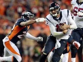 Texans quarterback Brock Osweiler (17) runs for a first down as Broncos cornerback Chris Harris (25) defends during second half NFL action in Denver on Monday, Oct. 24, 2016. (Joe Mahoney/AP Photo)