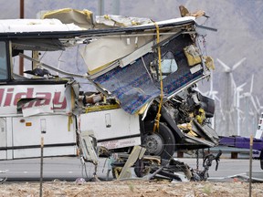 The damaged front of a tour bus is seen that crashed into the back of a semi-truck on Interstate 10 just north of the desert resort town of Palm Springs, in Desert Hot Springs, Calif., Sunday, Oct. 23, 2016. Several deaths and injuries were reported. (AP Photo/Rodrigo Pena)